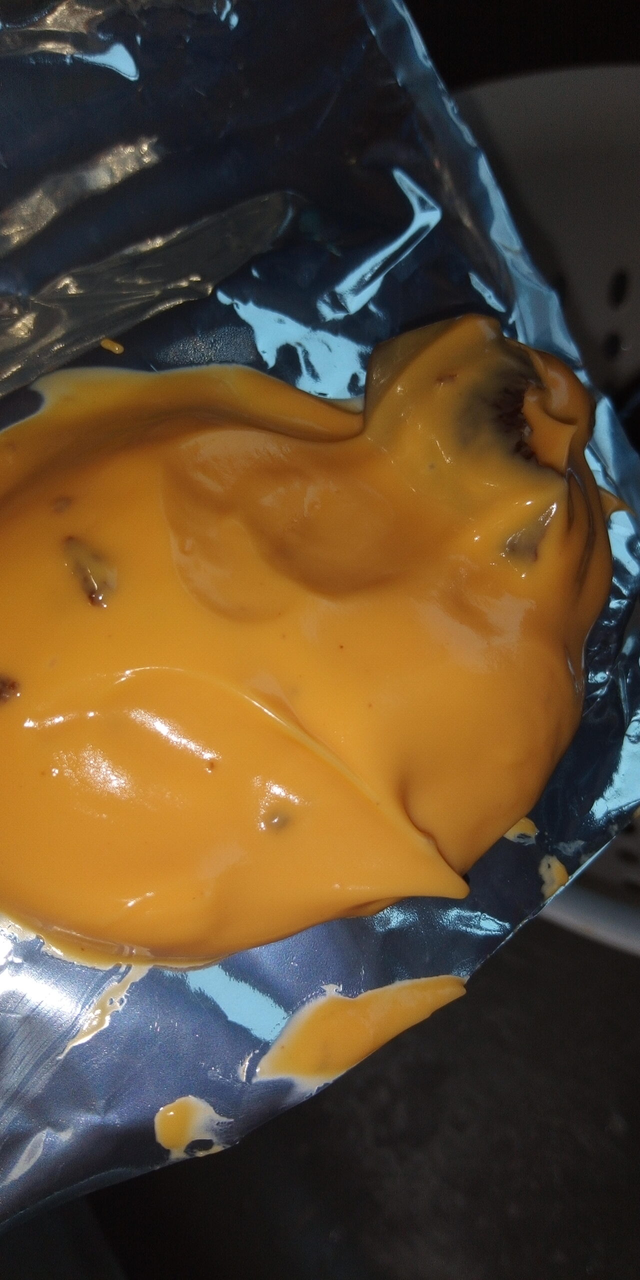 Brown chunks of mold in cheese